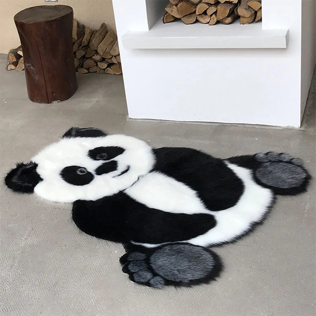 Tapis panda noir, blanc et gris posé près d’une cheminée