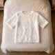Pull en maille effet plumes, coloris Blanc cassé, posé à plat