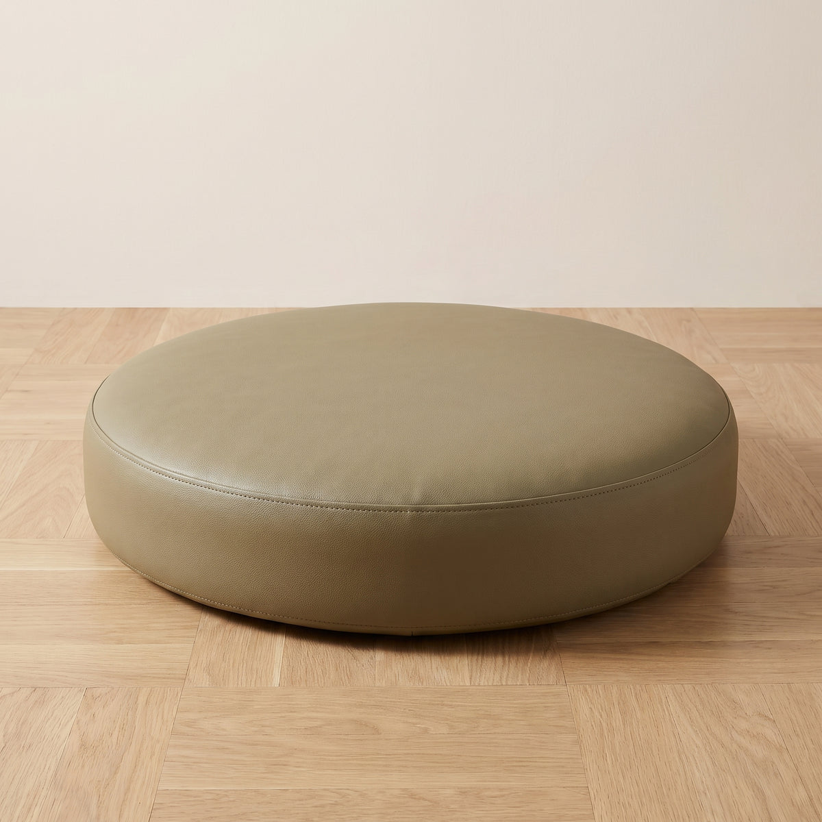 Coussin de sol rond en simili cuir beige