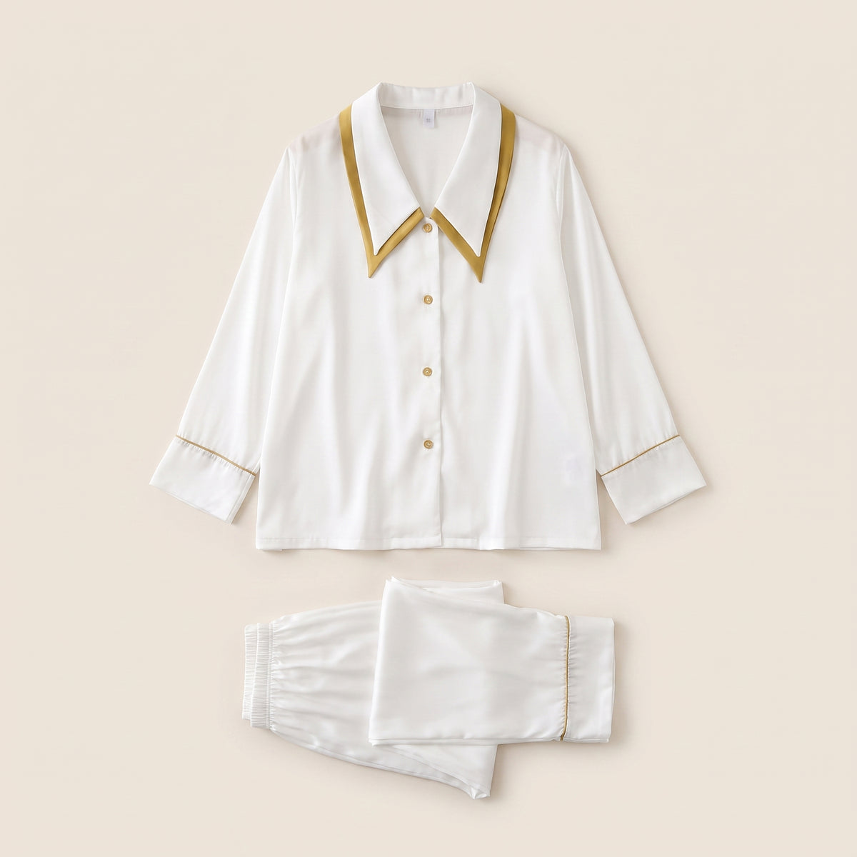 Pyjama en satin blanc à liseré moutarde, chemise et pantalon posés à plat