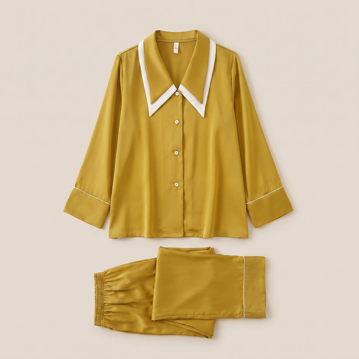 Pyjama en satin moutarde à liseré blanc, chemise et pantalon posés à plat
