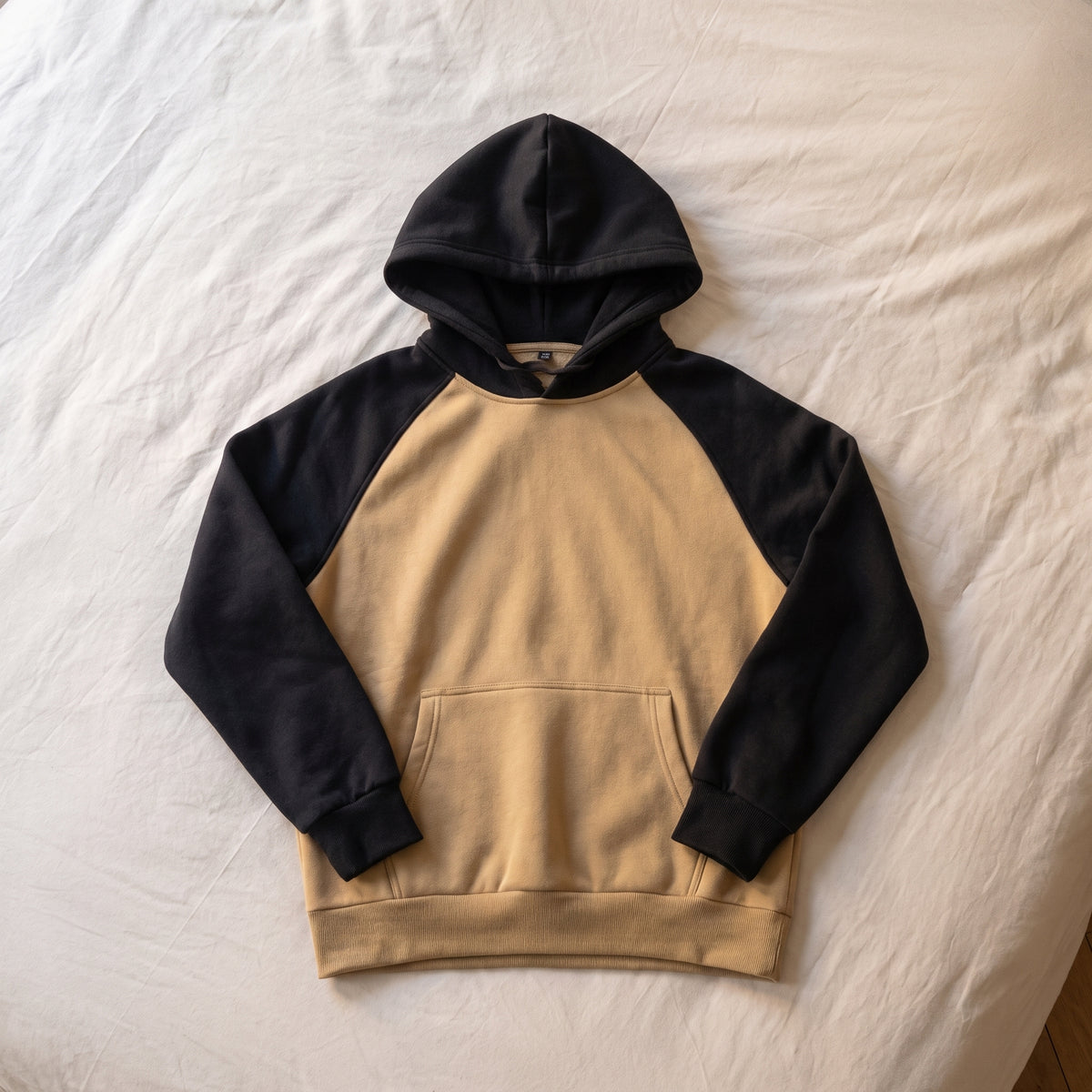 Sweat homme bicolore, Capuche beige et noir, posé à plat