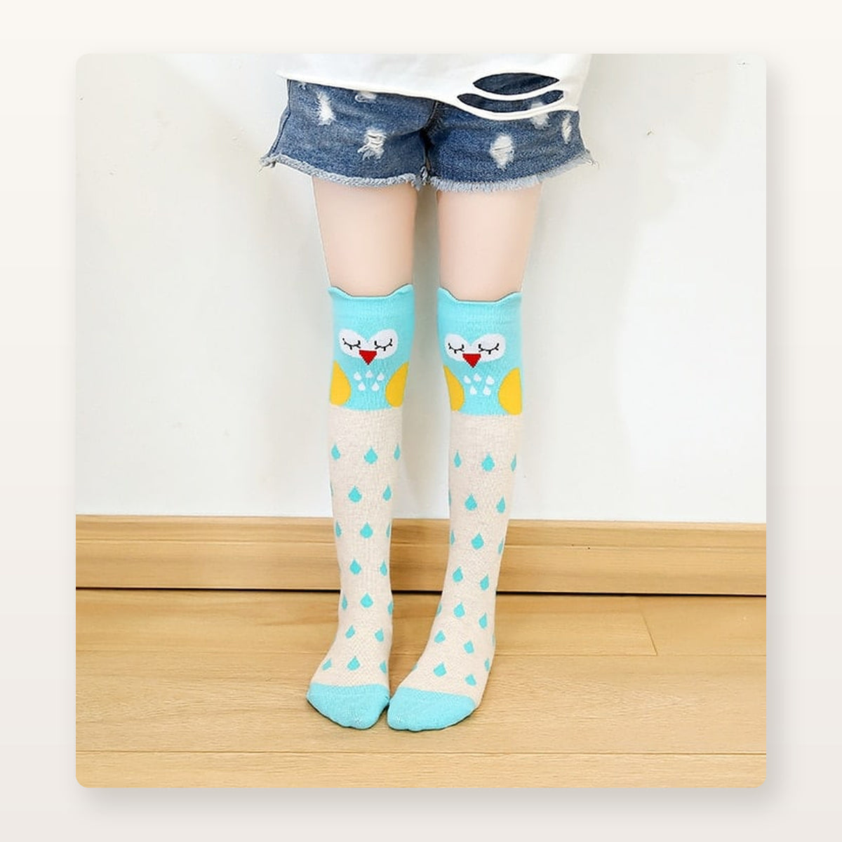 Chaussettes hautes enfant bleu clair à chouette et gouttes, portées sous le genou
