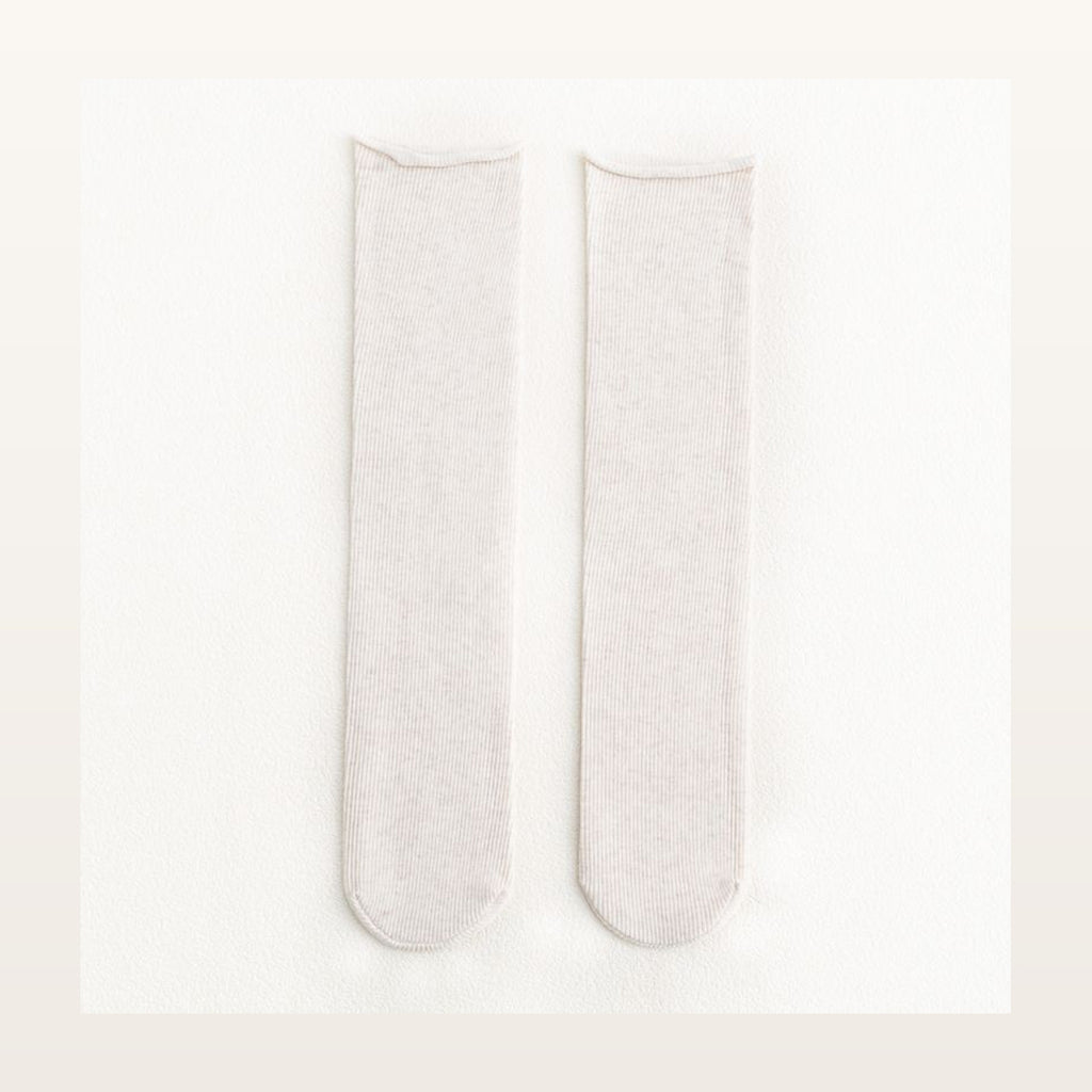 Paire de chaussettes longues unies blanches à maille côtelée