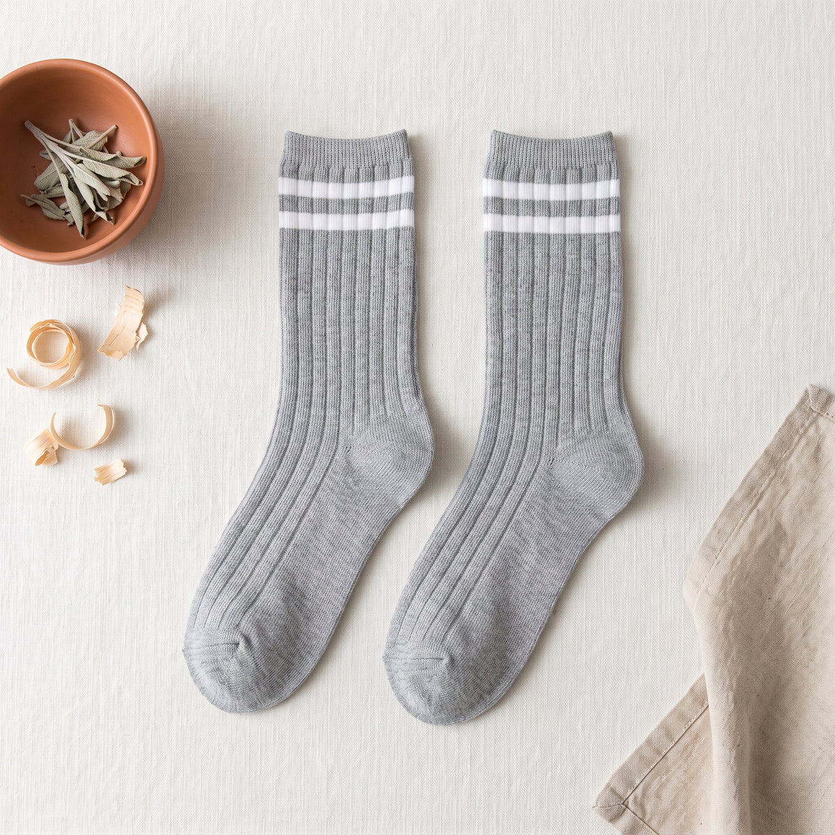Chaussettes américaines gris clair à deux rayures blanches sur fond lin