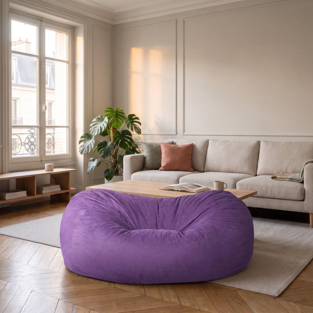 Housse de pouf immense violette posée au sol du salon