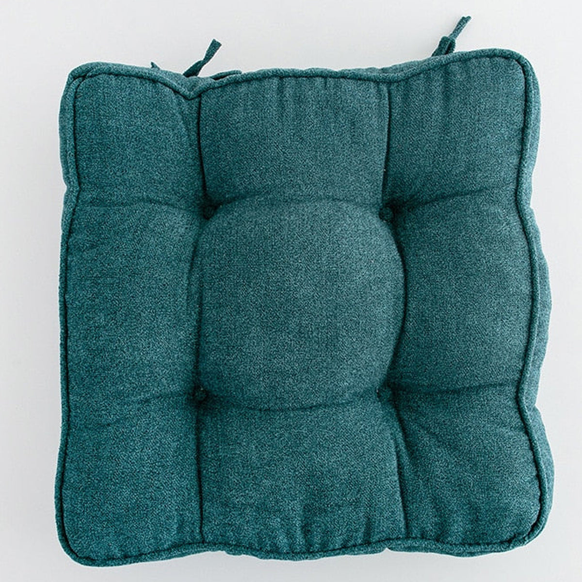 Détail du relief du coussin carré cyan capitonné