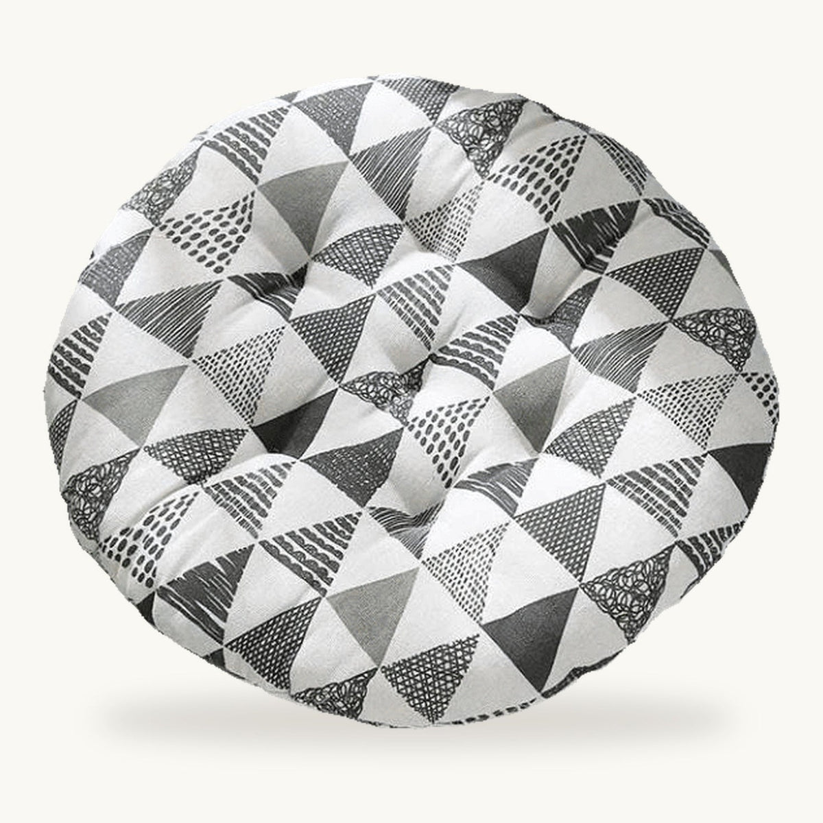 Coussin de sol rond capitonné à motif de triangles gris sur fond clair