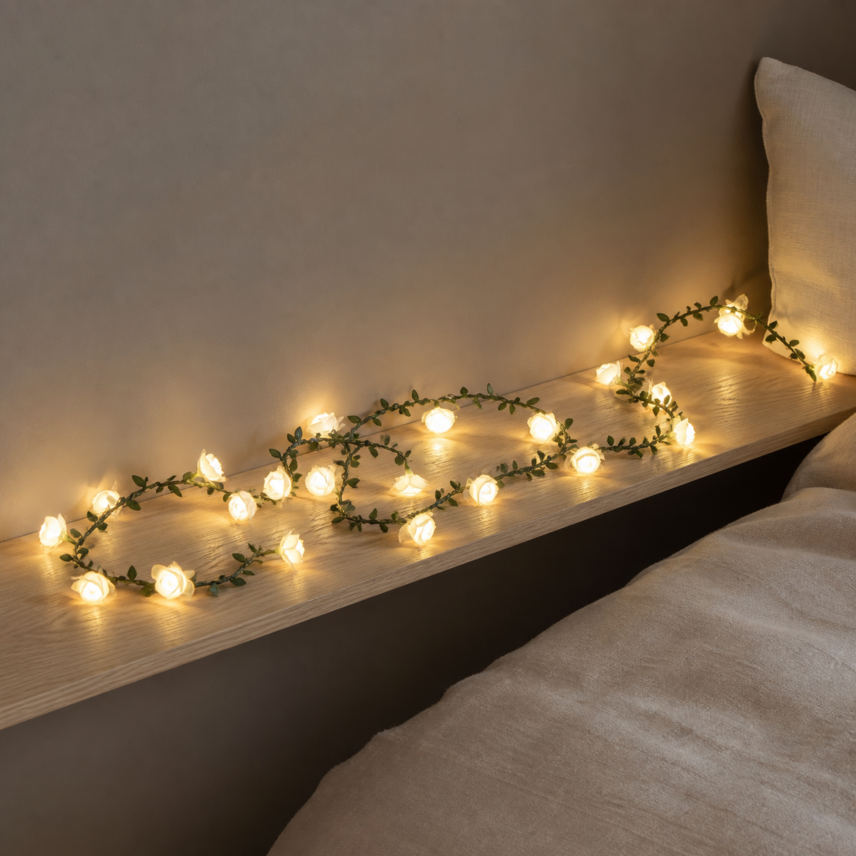Guirlande lumineuse à fleurs claires disposée sur une étagère de chambre