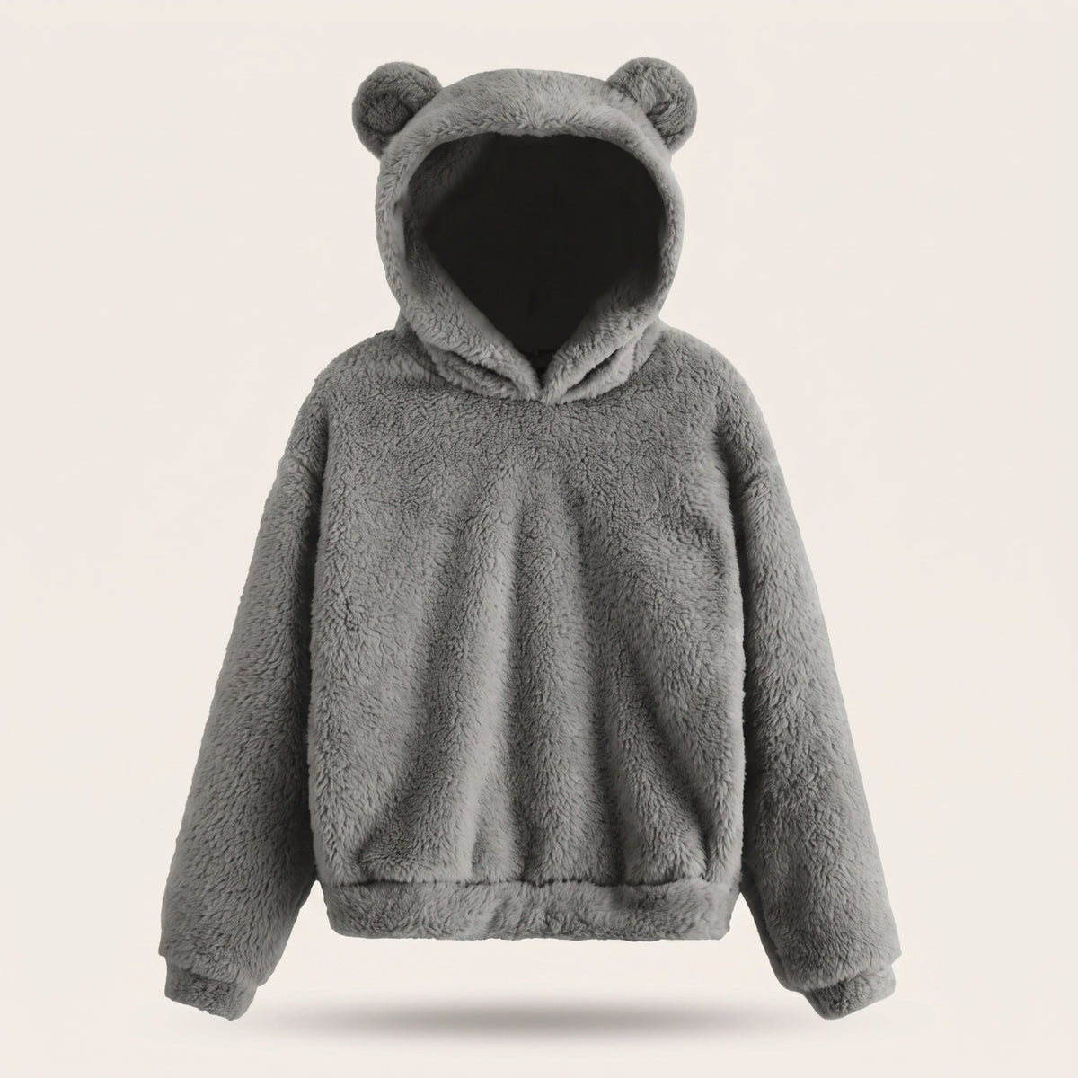 Le sweat ourson gris porte par un mannequin invisible, capuche relevee, manches galbees et bande froncee au bas du vetement