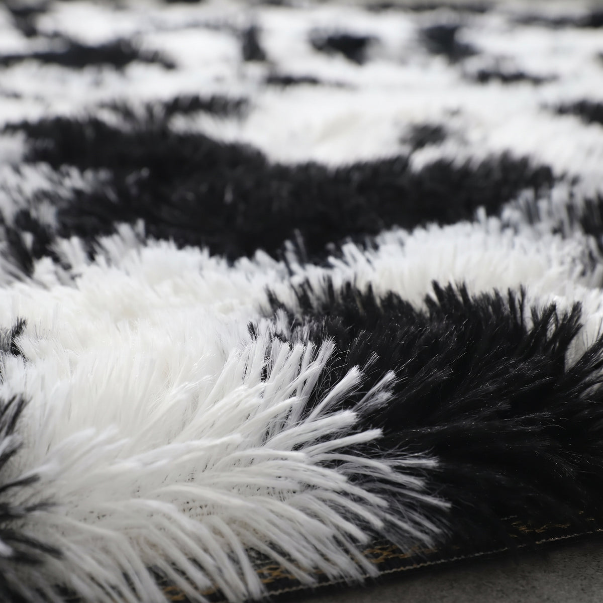Gros plan sur le poil long noir et blanc du tapis vache