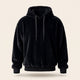 Le sweat peluche noir porte par un mannequin invisible, capuche relevee, cordon plat noir a embouts metalliques et bord-cote au bas et aux poignets