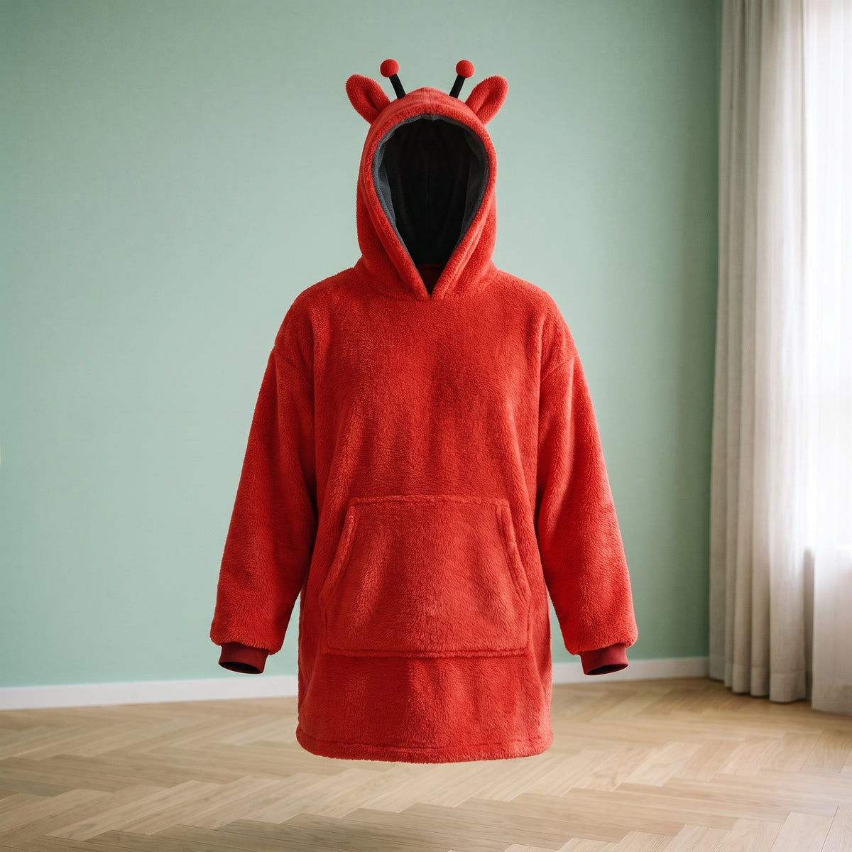 Plaid à capuche enfant coccinelle rouge, vu de face, la capuche relevée