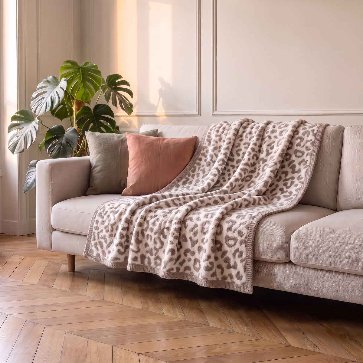 Plaid léopard beige déplié sur une assise de canapé écru Image