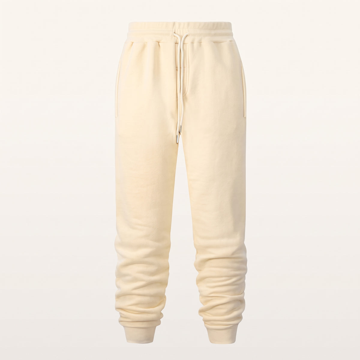 Ghost du pantalon de jogging beige sur fond uni, chevilles resserrées