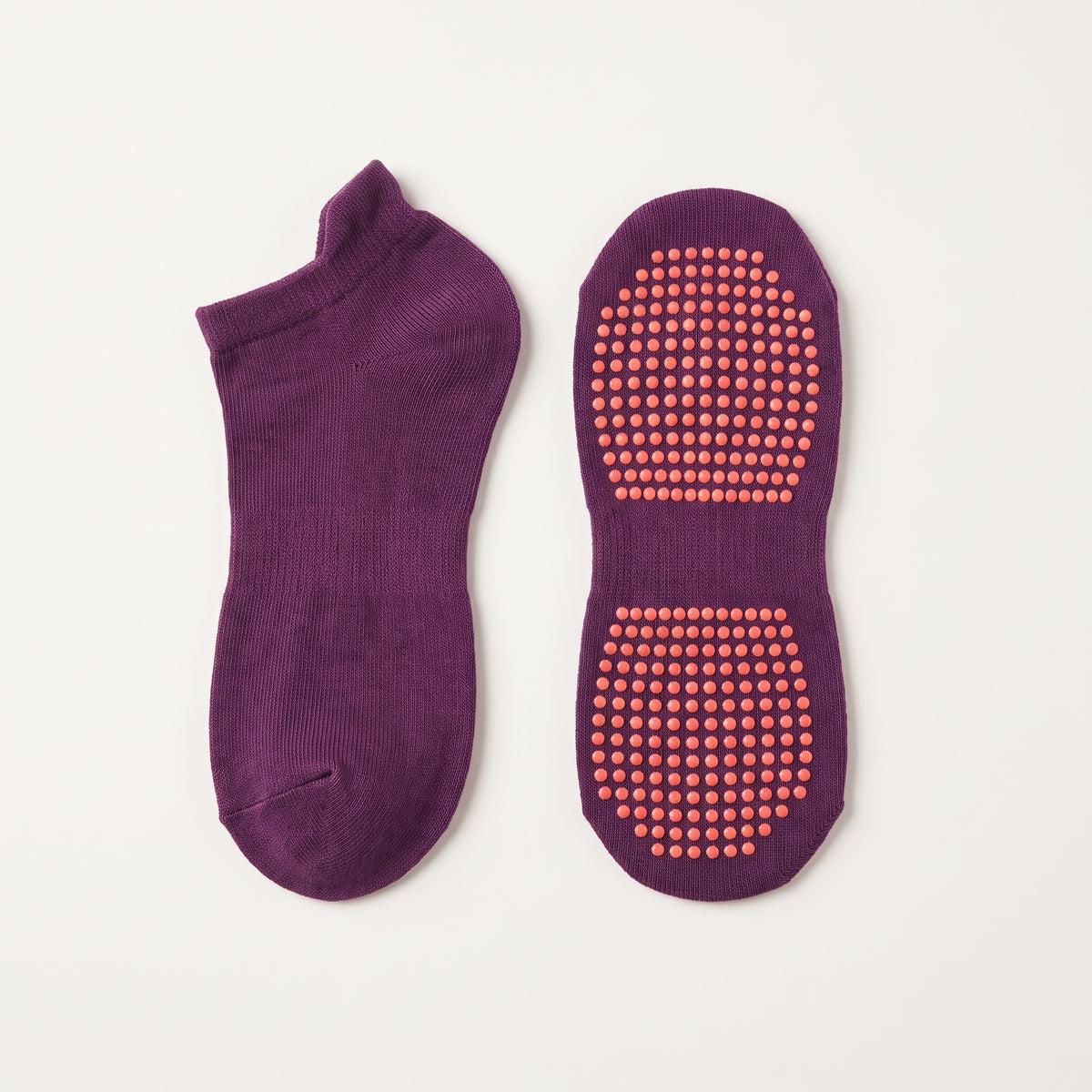 Chaussette basse antiderapante et sa semelle a picots, sur fond uni