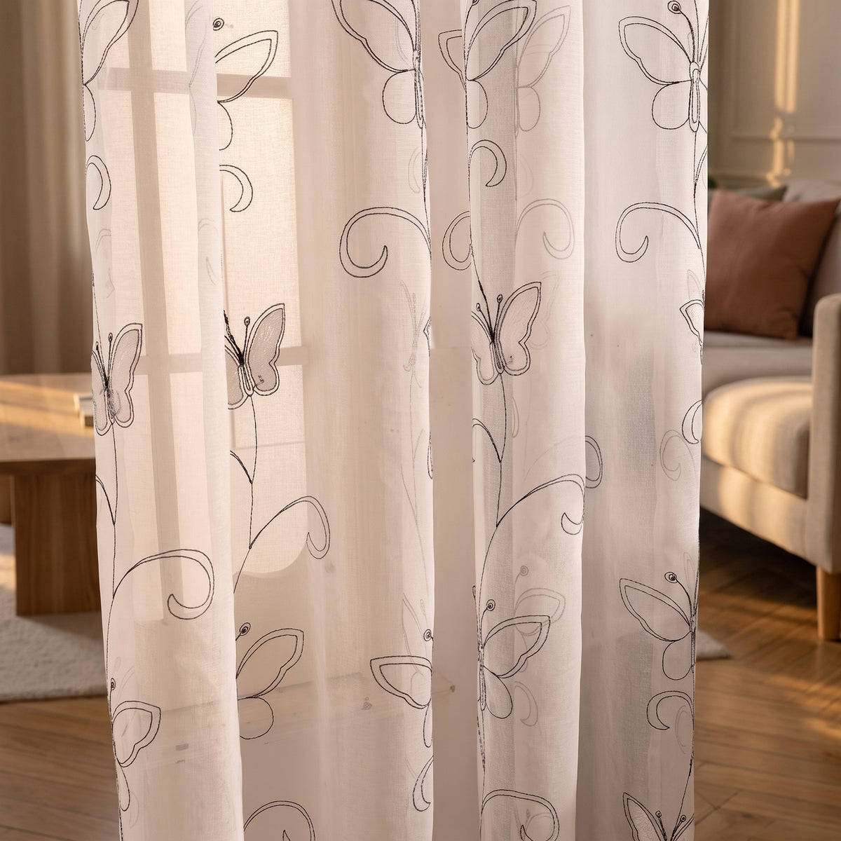 Détail des papillons gris et des lignes végétales du voilage