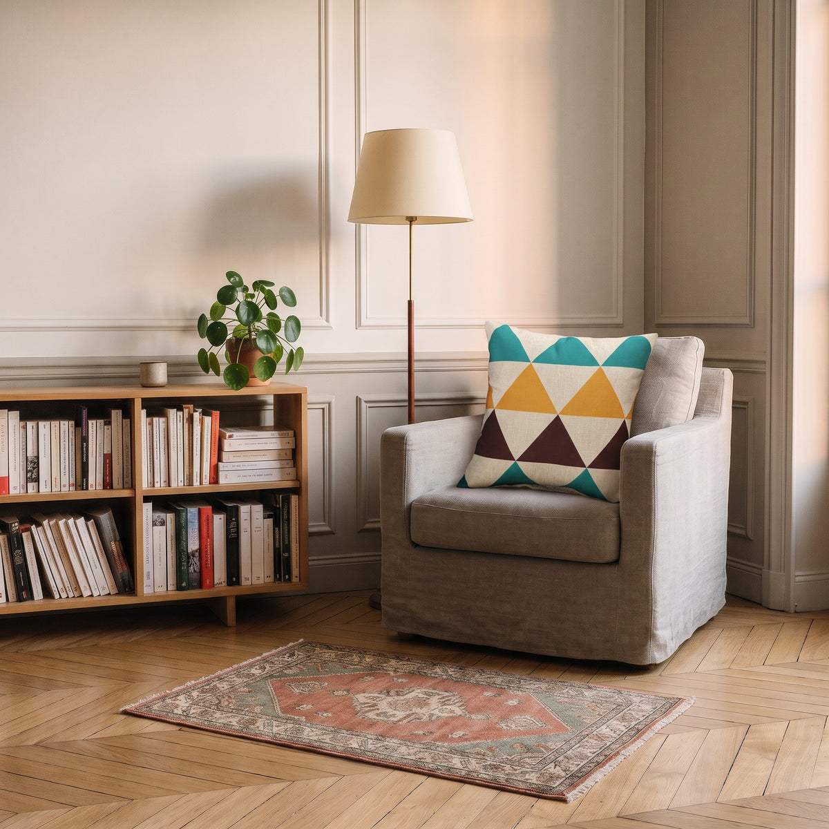 Housse de coussin à motif Triangles bleus et moutarde, posée dans un fauteuil de coin lecture
