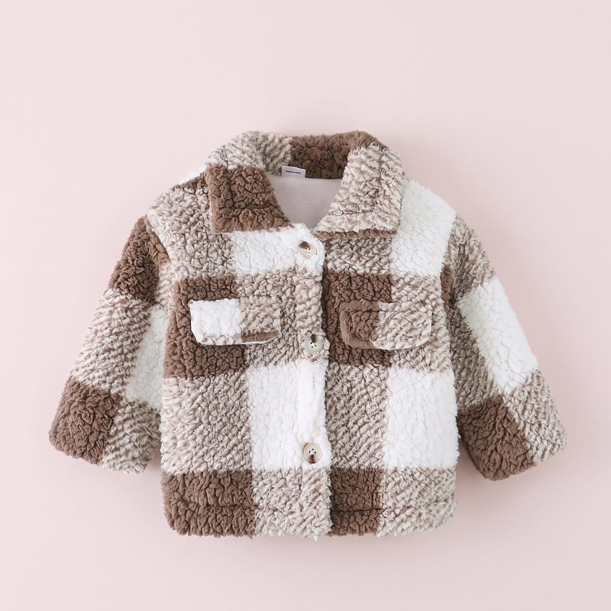 Manteau bébé à carreaux marron et écru présenté de face