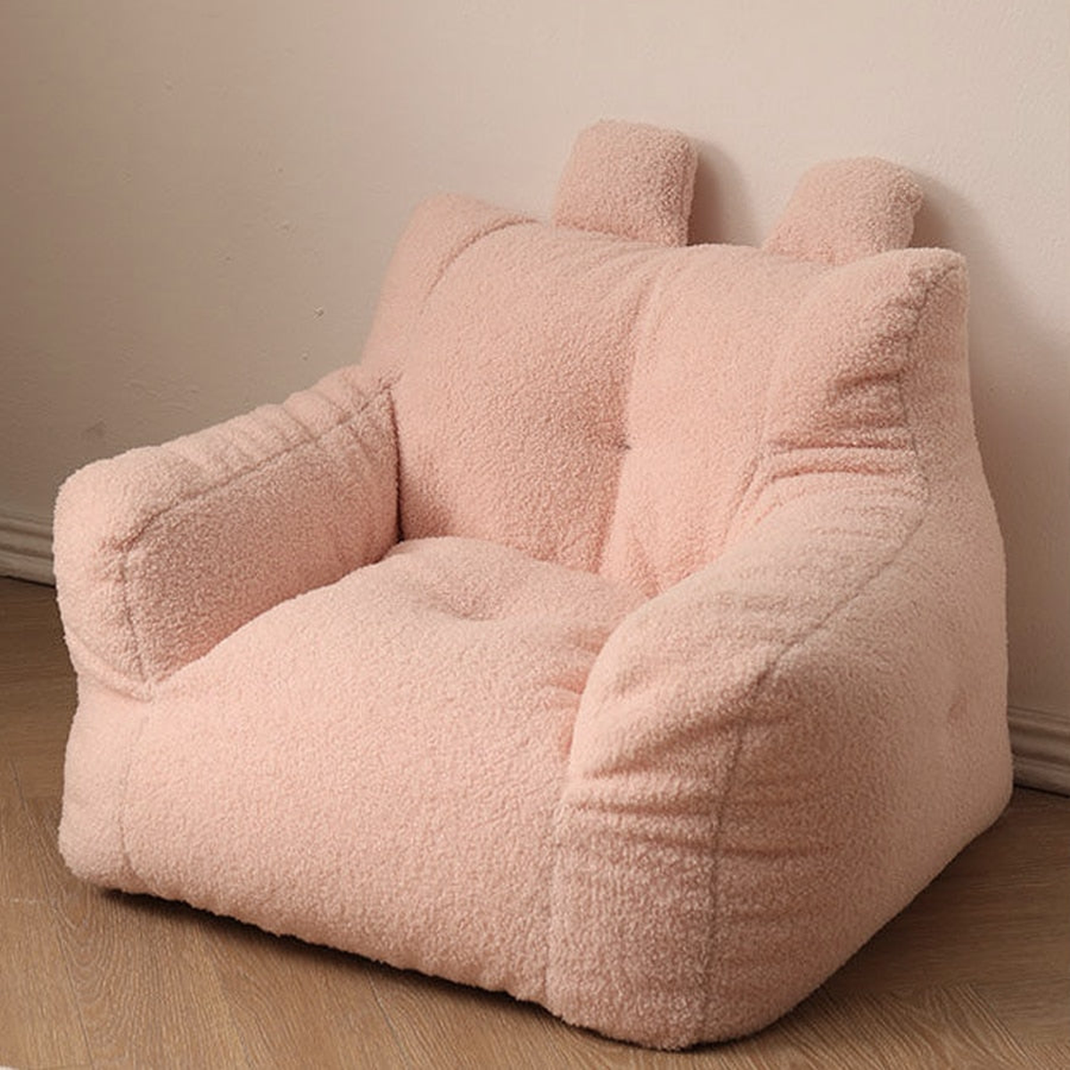 Fauteuil enfant rose en peluche avec dossier à deux oreilles et accoudoirs rembourrés