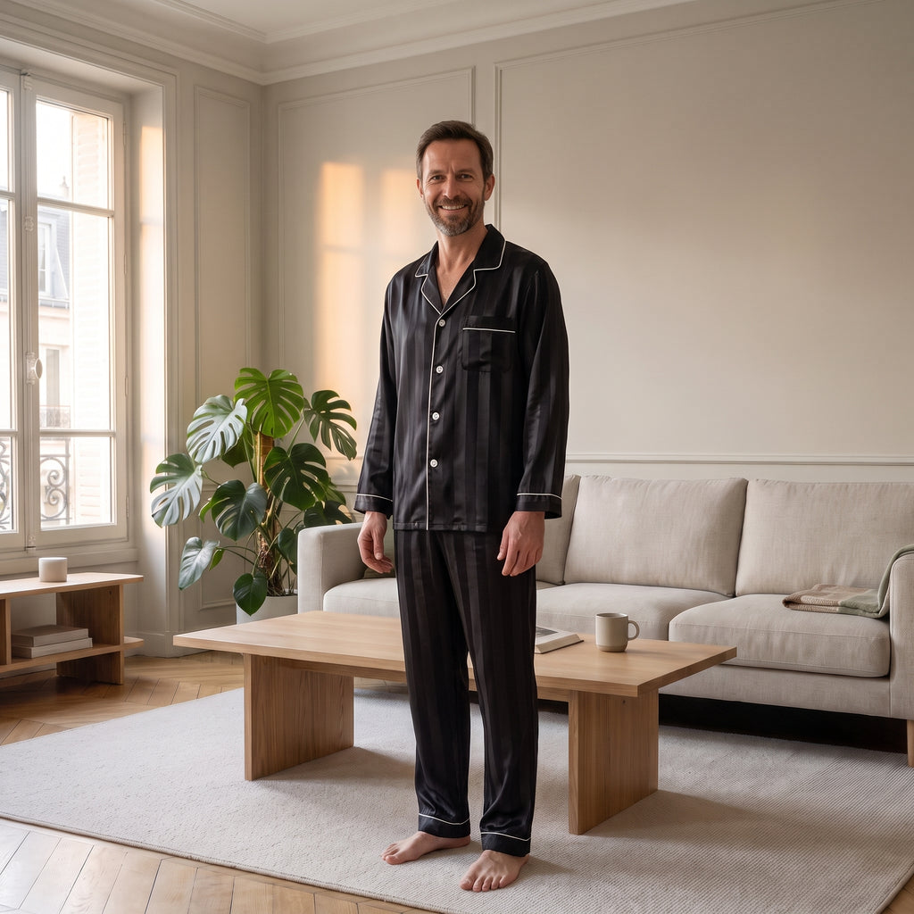 Homme du casting portant le pyjama noir debout près de la fenêtre