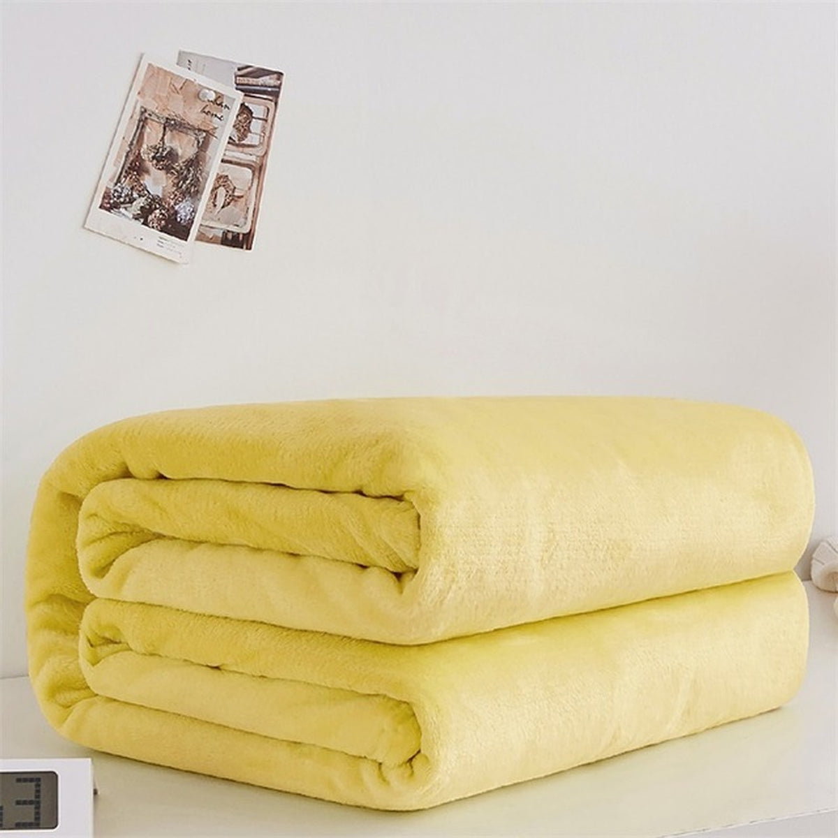 Plaid polaire léger en flanelle coloris jaune intense, plié sur fond clair