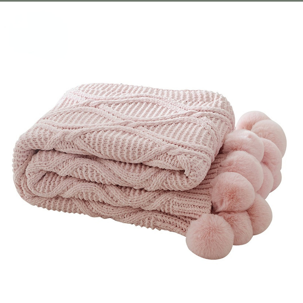 Plaid tricoté rose plié avec ses gros pompons