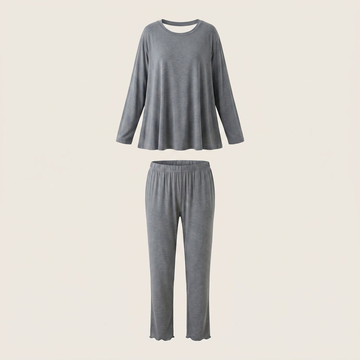 Haut et bas du pyjama en modal gris ardoise présentés en volume sur fond beige clair.