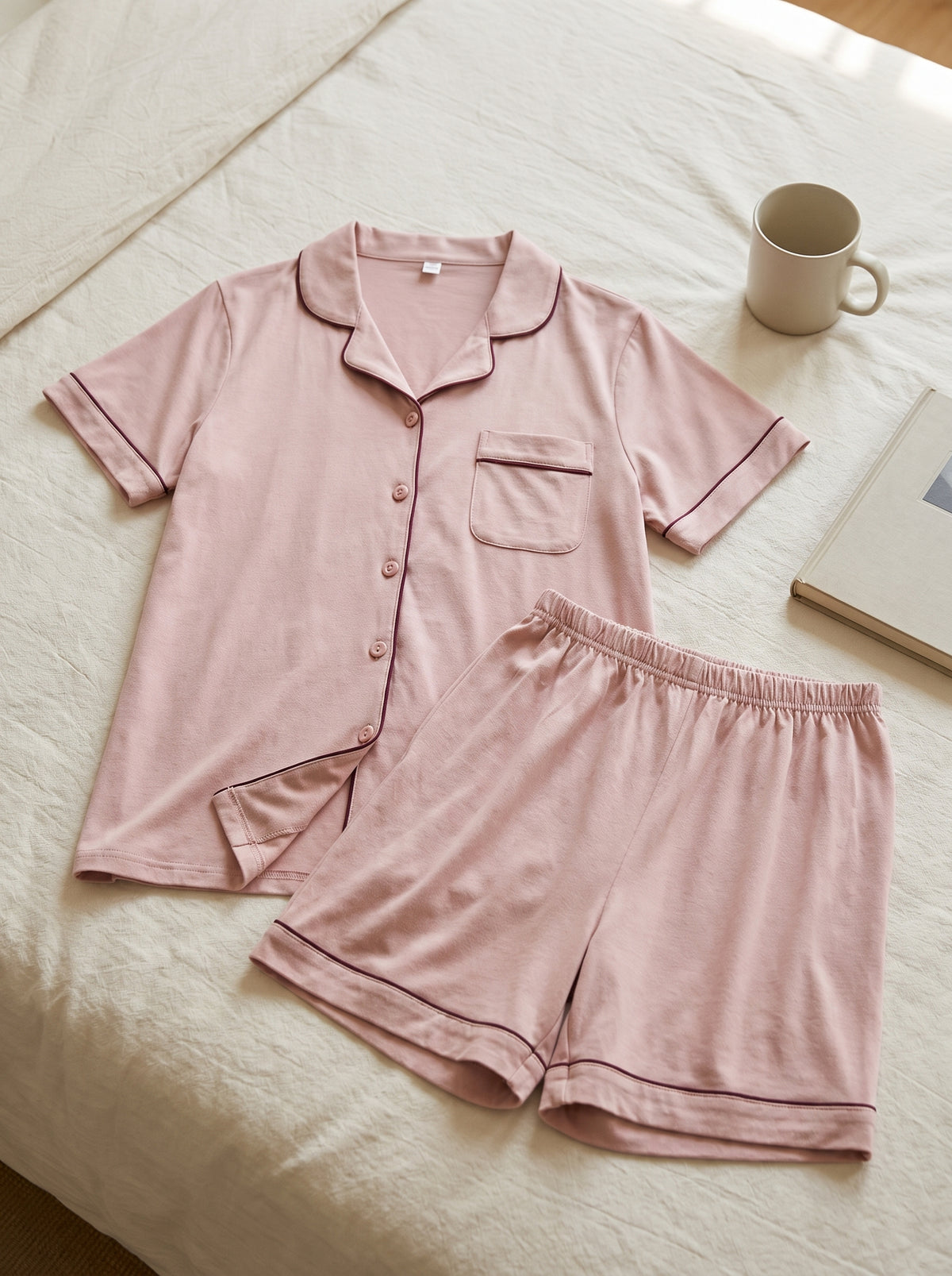 Chemise et short du pyjama d’été rose poudré présentés à plat.