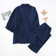 Pyjama homme kimono en gaze de coton bleu marine, haut croisé et pantalon, posés à plat