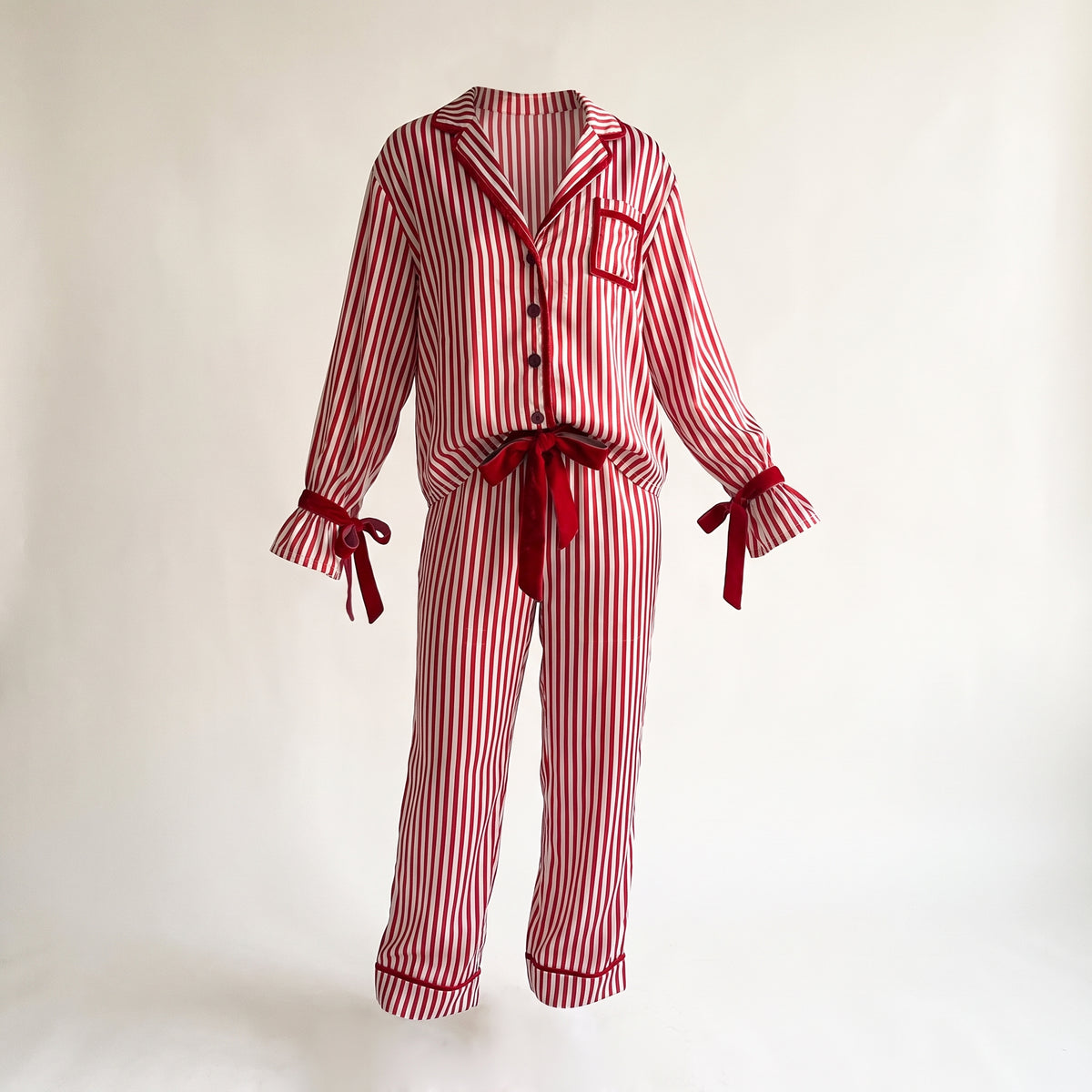 Pyjama de Noël femme rouge rayé avec trois boutons, sur fond uni