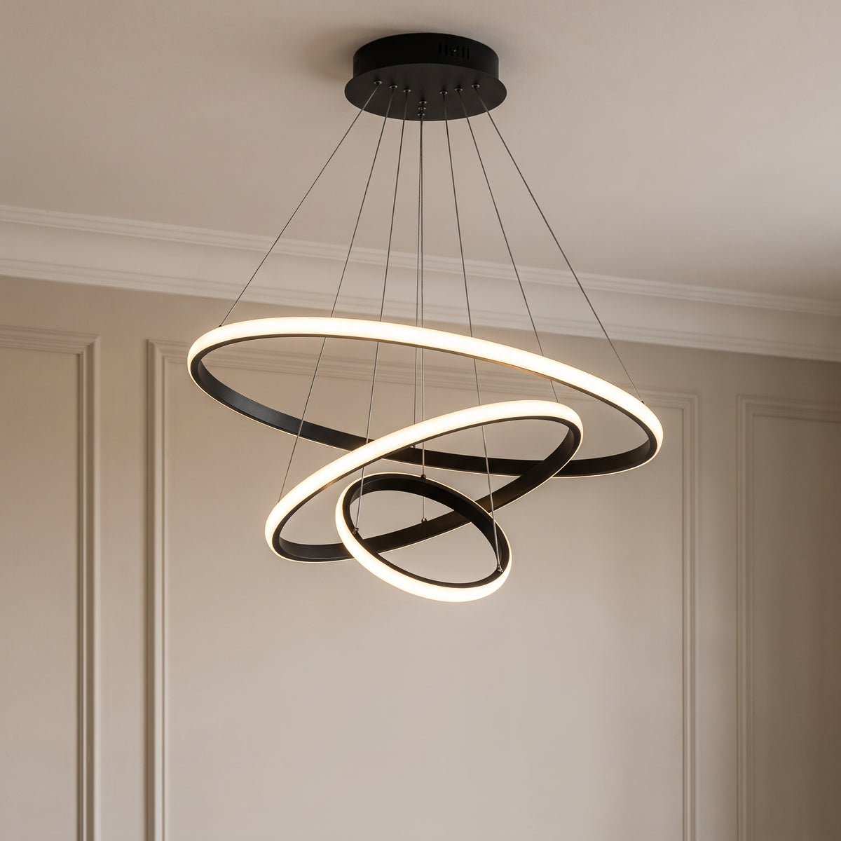 Vue rapprochée du plafonnier LED noir à trois anneaux avec câbles et pavillon rond