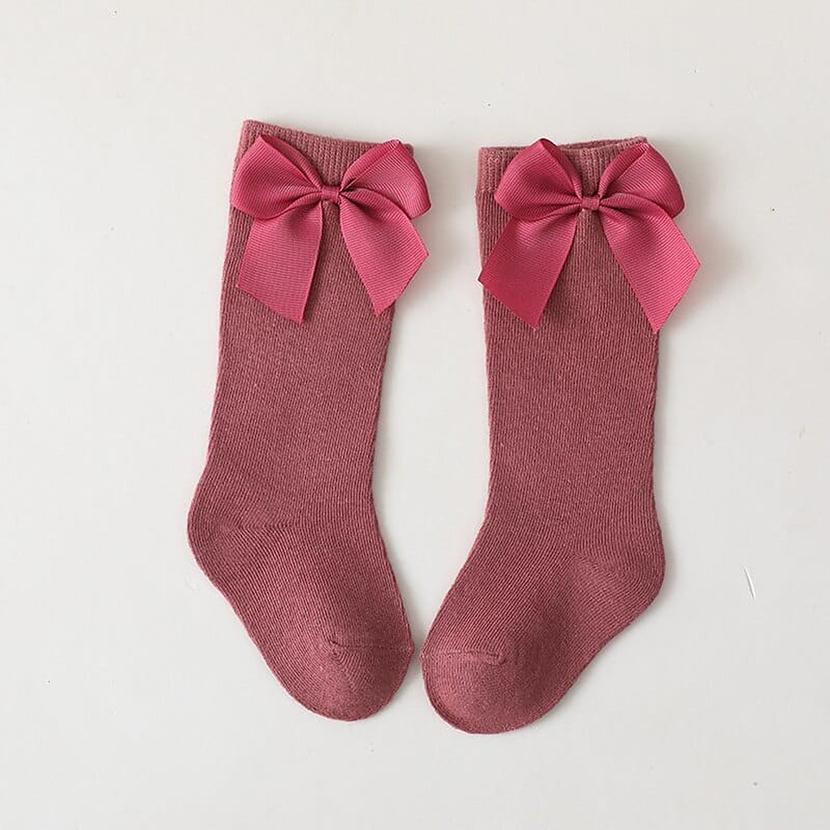 Paire de chaussettes hautes rose fonce a grand noeud pour enfant