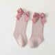Paire de chaussettes hautes roses a grand noeud pour enfant