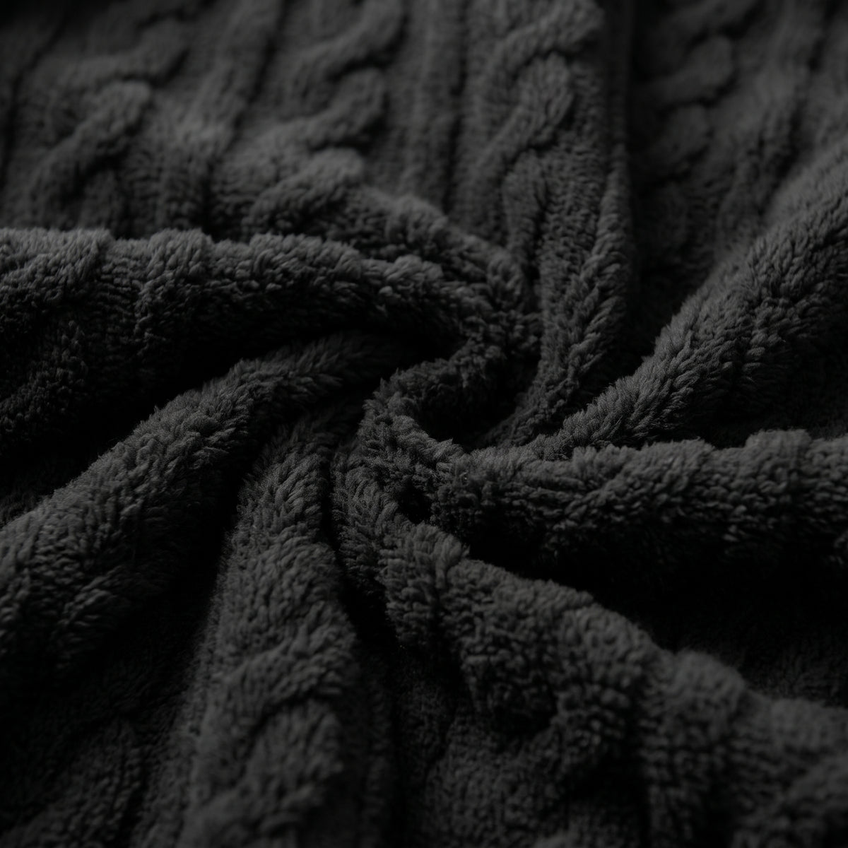 Plan macro du relief torsadé de la peluche noire de l’ensemble cocooning