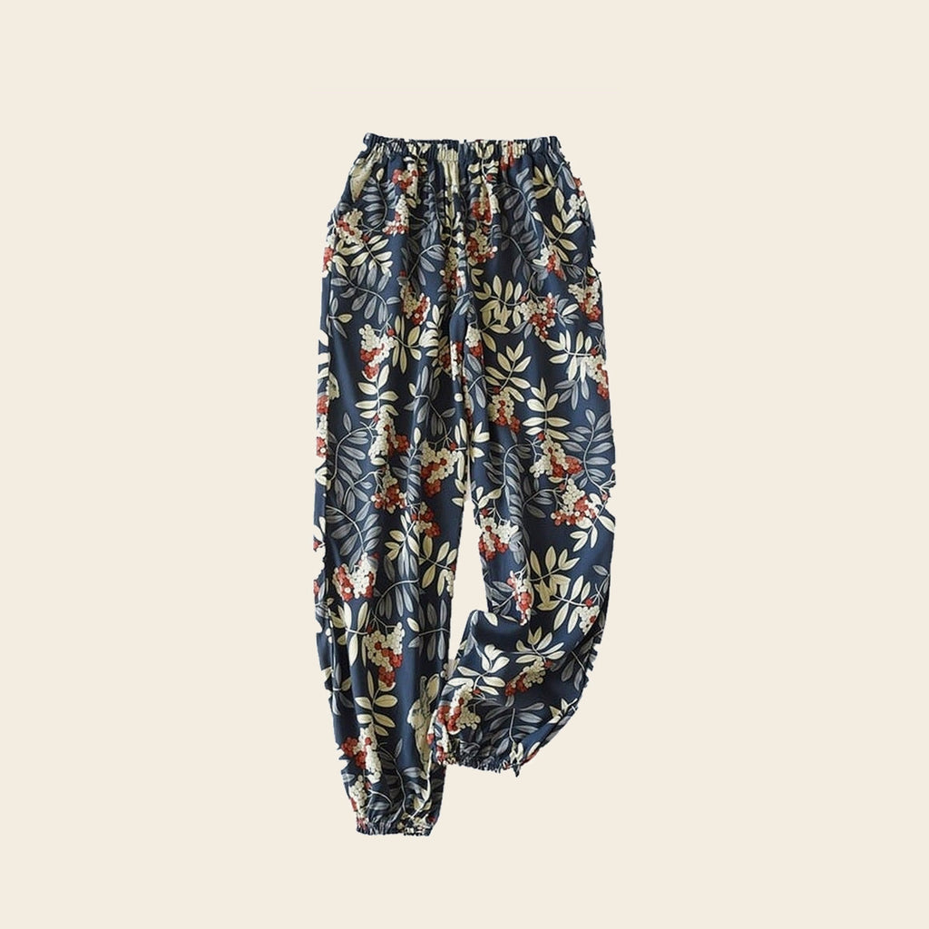 Pantalon cocooning femme bleu nuit à fleurs et feuillage, sur fond beige