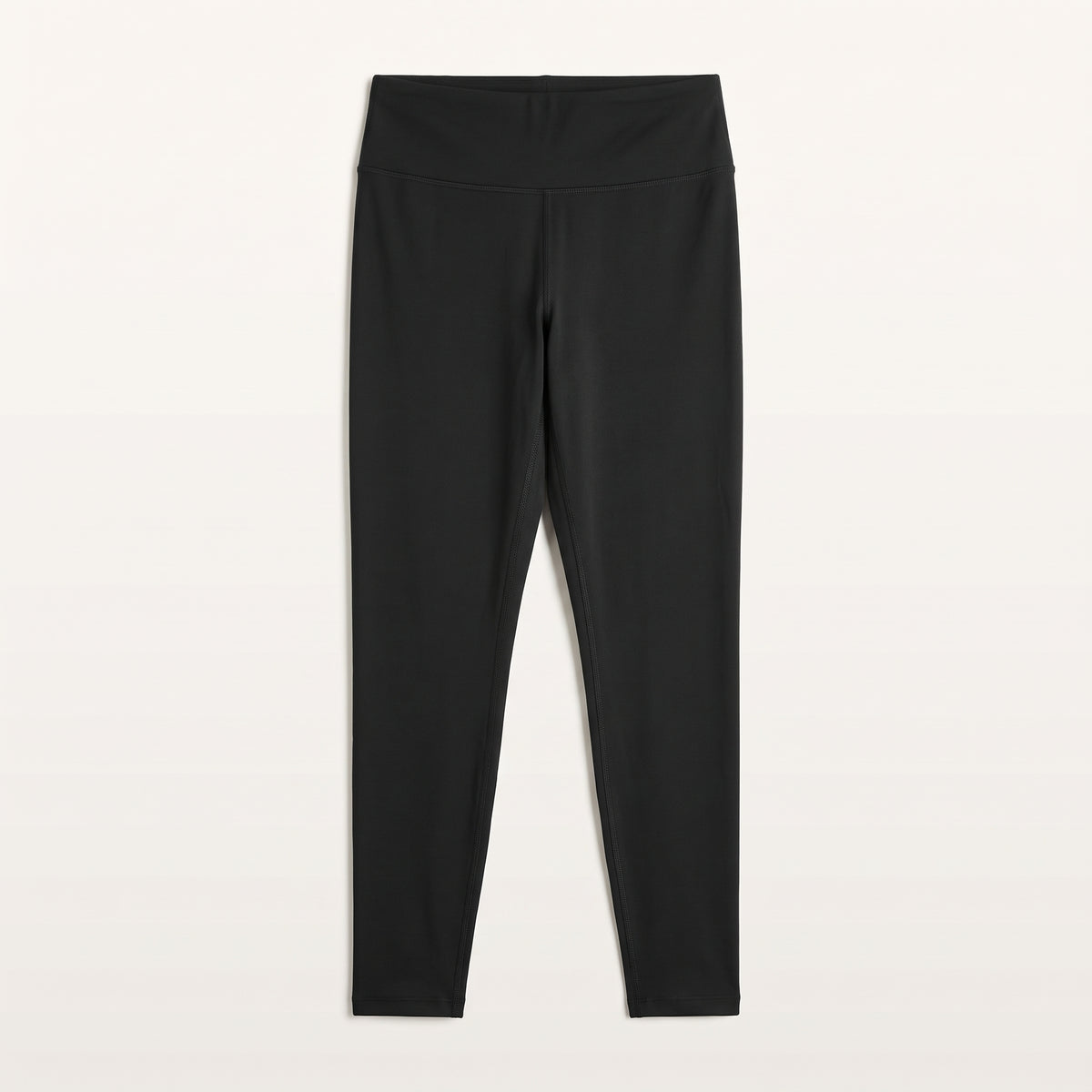 Legging de sport noir présenté à plat sur fond uni
