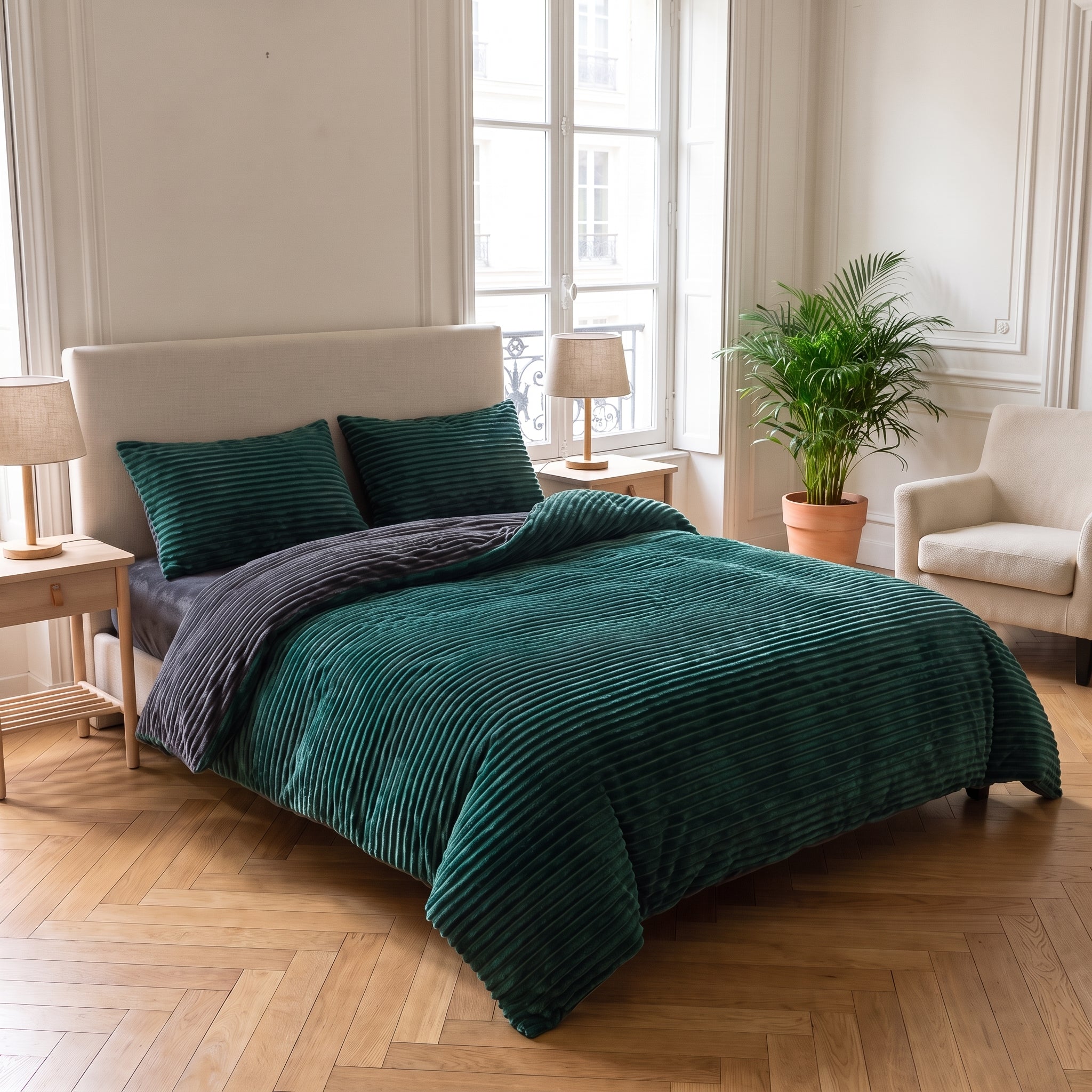 Lit double avec la parure verte côtelée dans une chambre haussmannienne lumineuse Image