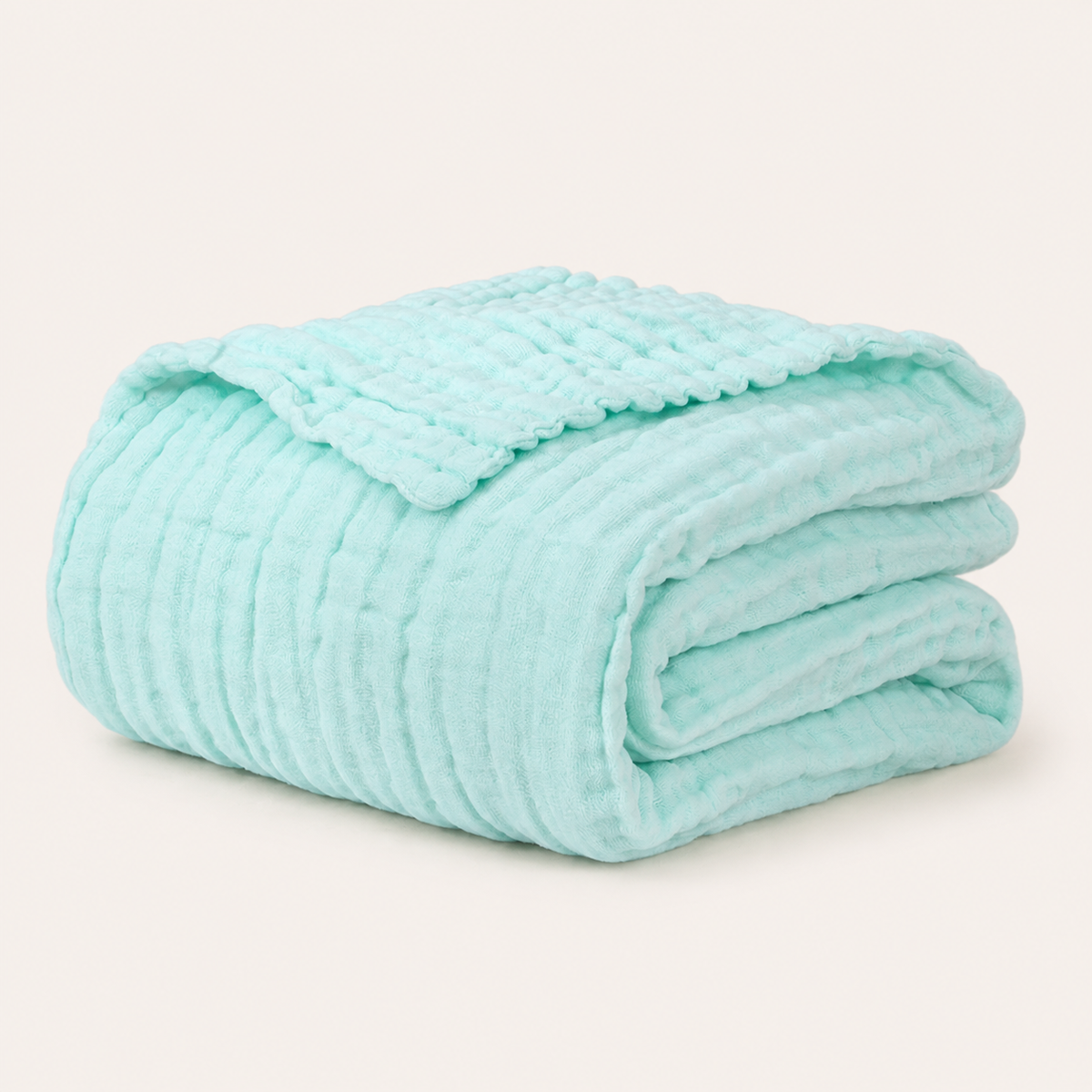 Couverture vert menthe en mousseline de coton pliée